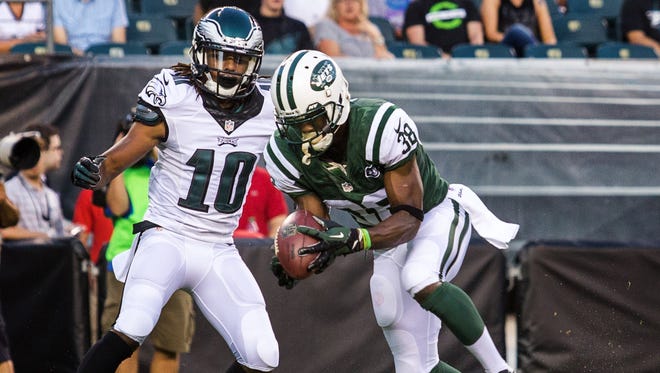 New York Jets corner LeQuan Lewis (No. 38) intercepts a pass intended for Eagles wide receiver Quron Pratt (No. 10) in the first quarter of a preseason football game at Lincoln Financial Field on Thursday night, August 28, 2014.
