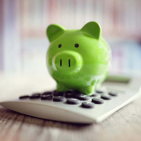 Piggy bank on calculator concept for saving, accounting, banking and business account