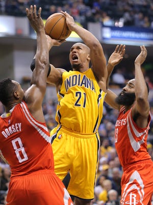 Indiana Pacers forward David West takes a shot over Houston Rockets center Joey Dorsey (left) and guard James Harden in the first half of the game at Bankers Life Fieldhouse on Monday night.