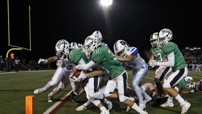 Dublin Coffman's Ian Carroll gets a little push from teammate Brady Broskie to score a  touchdown in Friday's 49-0 win over Hilliard Davidson. Coffman was ranked second in Division I in last week's state poll.