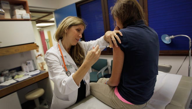 University of Miami pediatrician Judith Schaechter gives an HPV vaccination to a 13-year-old girl in 2011. Concerns that the vaccine might increase risky sexual activity are unsupported by a new study.