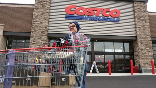 FILE - In this Nov. 12, 2014 file photo, Linda Bultema leaves the Costco store in Kalamazoo, Mich.  (AP Photo/Kalamazoo Gazette - MLive Media Group, Mark Bugnaski, File) ALL LOCAL TELEVISION OUT; LOCAL TELEVISION INTERNET OUT ORG XMIT: MIKAL301