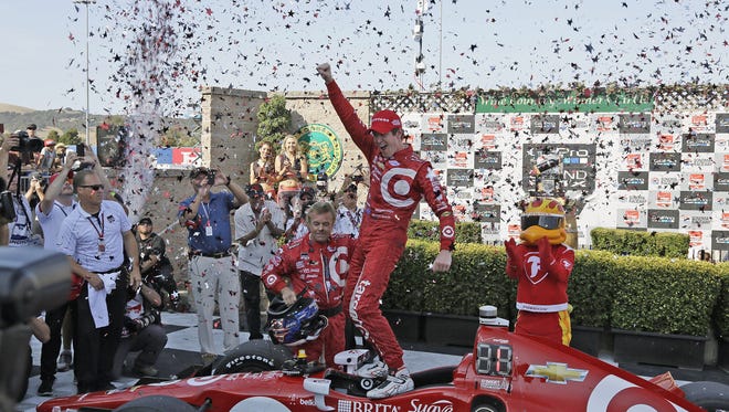 Scott Dixon, of New Zealand, celebrates atop his car after winning the IndyCar Grand Prix of Sonoma auto race and IndyCar championship Sunday, Aug. 30, 2015, in Sonoma, Calif. (AP Photo/Eric Risberg)