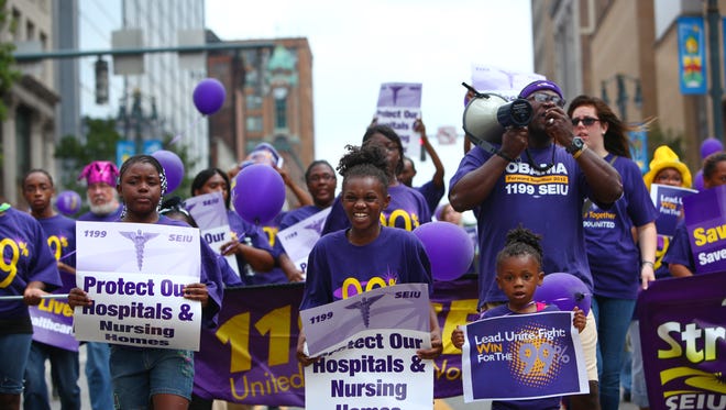 Local healthcare workers and their families march in the annual Labor Day Parade in downtown Rochester.