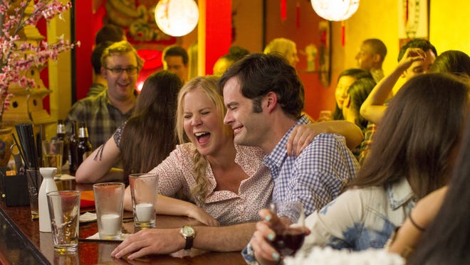 This photo provided by Universal Pictures shows, Amy Schumer , left, as Amy, and Bill Hader as Aaron, on a date in "Trainwreck," the new comedy from director/producer Judd Apatow. The movie releases in the U.S. on July 17, 2015.  (Mary Cybulski/Universal Pictures via AP)