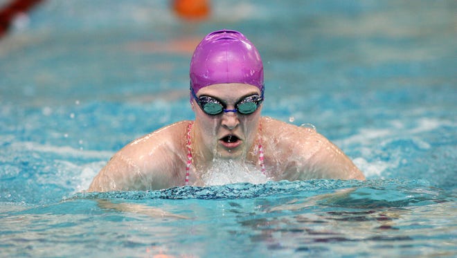 Lauren Cummons, 15, a freshman at Utica High School, practices recently with the Pau Hana swim club at Denison.