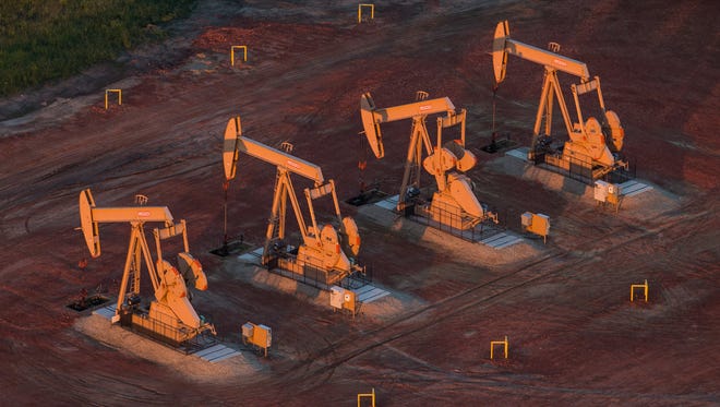 Getty Images
Pumpjacks are seen in an aerial view in July 2013 near Watford City, N.D. North Dakota has seen a boom in oil production thanks to new drilling techniques including horizontal drilling and hydraulic fracturing. Dakota Access LLC, a unit of Energy Transfer Partners, proposes to transport up to 570,000 barrels of light sweet crude oil daily from North Dakota?s Bakken oil fields through Iowa to Patoka, Ill.
Andrew Burton, Getty Images
WATFORD CITY, ND - JULY 30:  Pumpjacks are seen in an aerial view in the early morning hours of July 30, 2013 near Watford City, North Dakota. North Dakota has seen a boom in oil production thanks to new drilling techniques including horizontal drilling and hydraulic fracturing.  (Photo by Andrew Burton/Getty Images) ORG XMIT: 174362712 ORIG FILE ID: 175051434