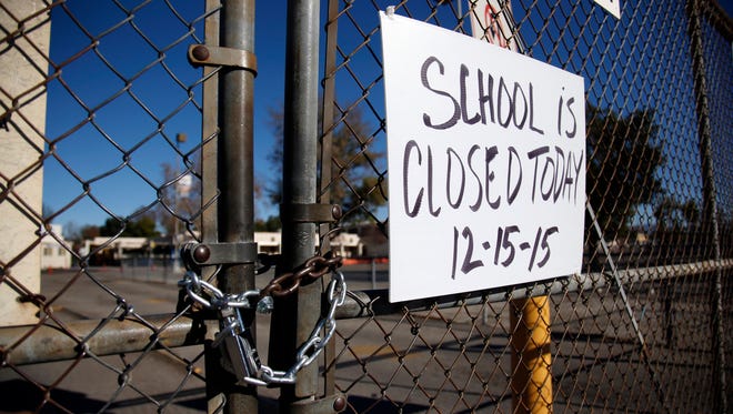A gate to Birmingham Community Charter High School in the Van Nuys section of Los Angeles is locked on Dec. 15 following a threat made to the school's district office. More than two dozen Delaware schools also have gotten fake threats in recent months, part of a national trend.