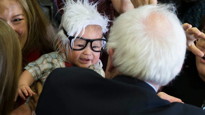 Democratic presidential candidate Sen. Bernie Sanders meets 3-month-old Oliver Jack Carter Lomas-Davis.