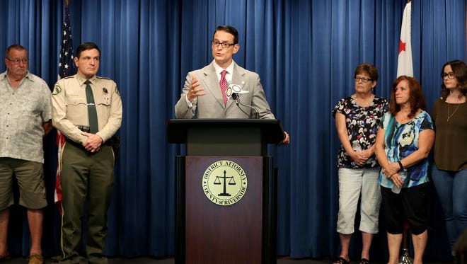 Riverside County District Attorney Mike Hestrin announces charges against two men in a decade-old triple homicide case in Pinyon Pines during a news conference in Riverside.