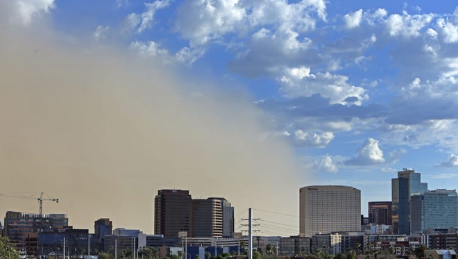 A dust storm encroaches on downtown Sunday, Aug. 21, 2016 in Phoenix,  Ariz.