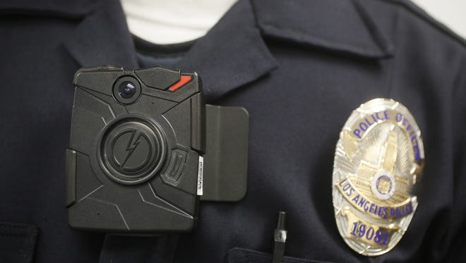 Damian Dovarganes/AP
Many police departments have policies calling for officers to turn on their body cameras before initiating contact with a citizen in most cases. But there are usually no penalties for failure to switch on the device.
FILE- In this Jan. 15, 2014, file photo a Los Angeles Police officer wears an on-body camera during a demonstration in Los Angeles. The critical moment when a gunman opened fire on two San Diego police officers, killing one, wasn't captured on the camera one of the officers was wearing because he didn't turn it on until after bullets flew. It's the latest example of the hole created by policies like San Diego's that allow officers to determine when to start recording. (AP Photo/Damian Dovarganes, File)