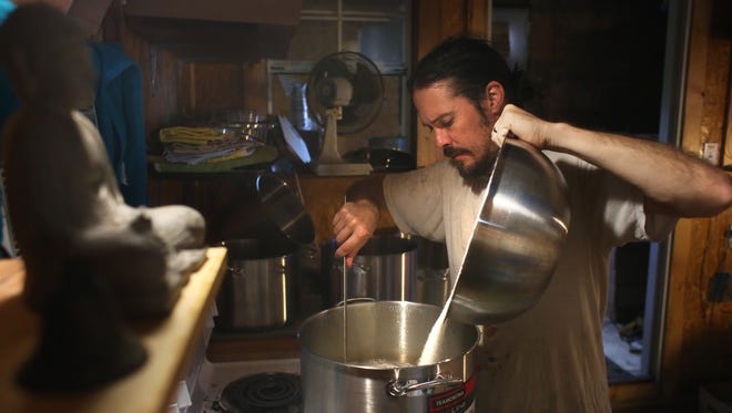 Kentucky Kombucha owner Paul Haney produces a batch of fermented tea.