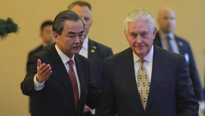 Chinese Foreign Minister Wang Yi (L) and U.S. Secretary of State Rex Tillerson arrive for a joint press conference at Diaoyutai State Guesthouse on March 18 in Beijing. Tillerson is on his first visit to Asia as Secretary of State.