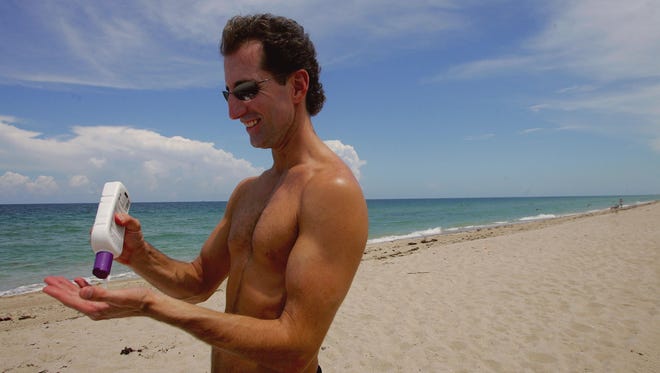 FORT LAUDERDALE, FL - JUNE 20:  Rick Johnson applies sun tan lotion during a visit to the beach June 20, 2006 in Fort Lauderdale, Florida. Recent studies have shown that the best way to protect against melanoma from the sun is to use a sunscreen that includes zinc oxide, titanium dioxide or avobenzone. People exposed to the sun should look for water-resistant sunscreen with a Sun Protection Factor (SPF) of 30 or higher.  (Photo by Joe Raedle/Getty Images)