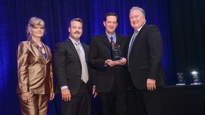 Richard Williams (center right), CEO of RAM Inc., accepts an award from Lockheed Martin Missiles and Fire Control representatives.