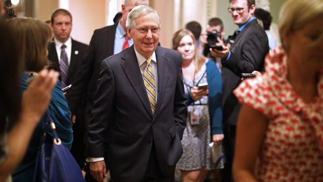 Majority Leader Mitch McConnell heads to the Senate floor following a meeting where he shared a new version of the health care bill with fellow GOP senators on July 13, 2017.
