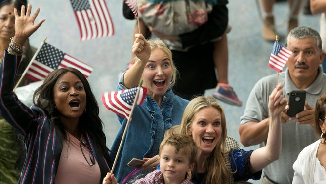Family members react as they welcome their relatives as new U.S. citizens after taking the citizenship oath during naturalization ceremonies at a U.S. Citizenship and Immigration Services ceremony in Los Angeles on Wednesday.