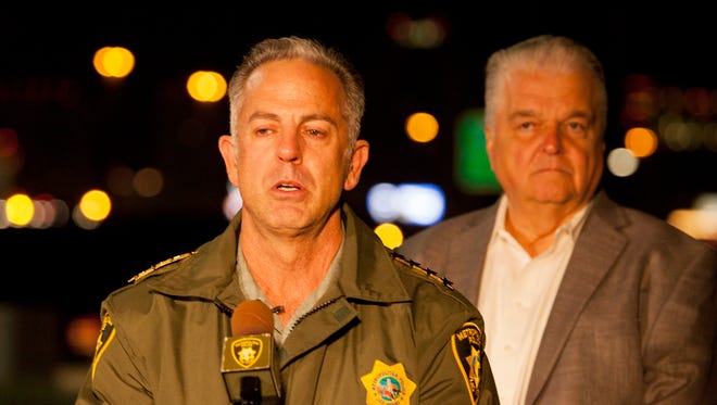 Clark County Sheriff Joe Lombardo briefs members of the media outside Metro Police headquarters early Monday, Oct. 2, 2017, after a mass shooting at a music festival on the Las Vegas Strip on Sunday. Clark County Commission Chairman Steve Sisolak stands behind Lombardo at right. (Yasmina Chavez/Las Vegas Sun via AP)