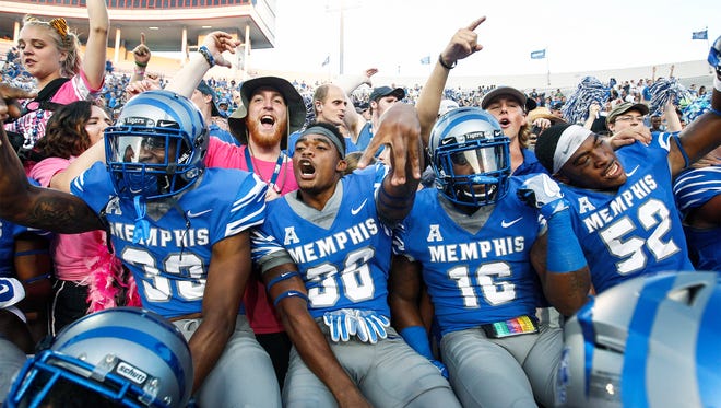 University of Memphis players celebrate with fans after a 30-27 victory over Navy at Liberty Bowl Memorial Stadium in Memphis, Tenn., Saturday, October 14, 2017.