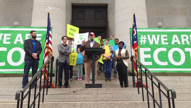 FILE – In this May 9, 2017, file photo, Bill Lager, center, co-founder of Ohio's largest online charter school, the Electronic Classroom of Tomorrow or ECOT, speaks to hundreds of supporters during a rally outside the Statehouse in Columbus, Ohio. The virtual school could lose its required sponsor and abruptly close in early 2018, although ECOT has said it's working to remain open. Wednesday, Jan. 17, 2018, is the school's deadline to send a proposed remedy to the sponsor, Educational Service Center of Lake Erie West. (AP Photo/Julie Carr Smyth, File)