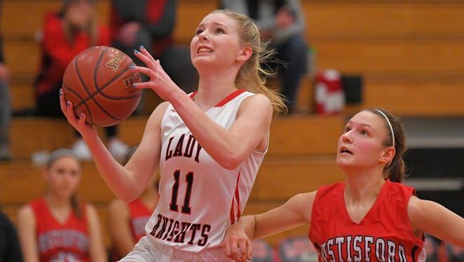 Alexis Rolph (11) of Lourdes drives past Hustisford's Nicole Lueck (10) on Thursday.