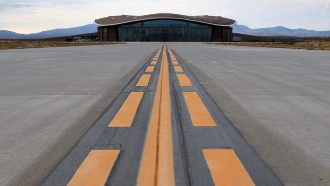 FILE - This Dec. 9, 2014, file photo shows the taxiway leading to the hangar at Spaceport America in Upham, N.M. Operators of the New Mexico Spaceport Authority that runs Spaceport America in southern New Mexico are seeking greater confidentiality for tenants that include aspiring commercial spaceflight company Virgin Galactic. (AP Photo/Susan Montoya Bryan, file)