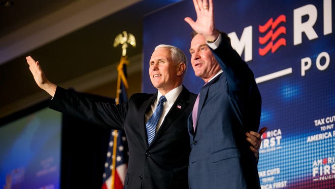 Michigan Attorney General Bill Schuette takes the stage with Vice President Mike Pence at a March 2 event hosted by "America First Policies"  at the Westin Book Cadillac Hotel in Detroit.