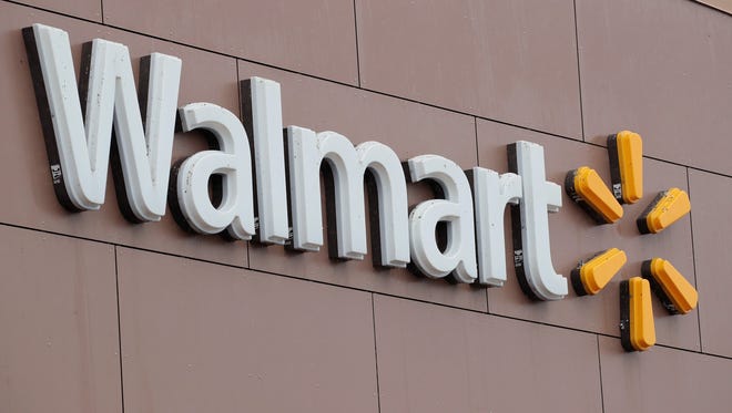 fThis file photo taken in 2018 shows a Walmart sign outside one of the retailing giant's stores in Chicago, Ill.