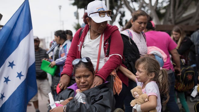 Members of a Central American family traveling with a caravan of migrants prepare to cross the border and apply for asylum in the United States, in Tijuana, Mexico, Sunday, April 29, 2018. A group of Central Americans who journeyed in a caravan to the U.S. border resolved to turn themselves in and ask for asylum Sunday in a direct challenge to the Trump administration - only to have U.S. immigration officials announce that the San Diego crossing was already at capacity.