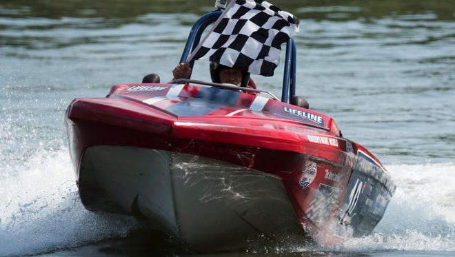 Jerry Rinker, of Houston, Tx., displays the checkered flag after taking first in the tri-hull competition of the Thunder on the Cumberland event on the Cumberland River on Saturday, June 16, 2018, in Nashville, Tenn. 