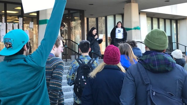A speaker addresses protesters outside the Hannah Administration Building on Friday, March 23, 2018.