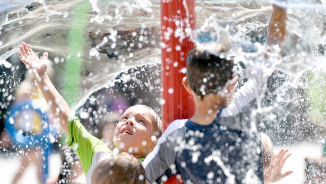 In this 2016 photo, Tyler Hughes, then 6, of Marietta, far left, plays at the splash pad in Red Lion's Fairmount Park.