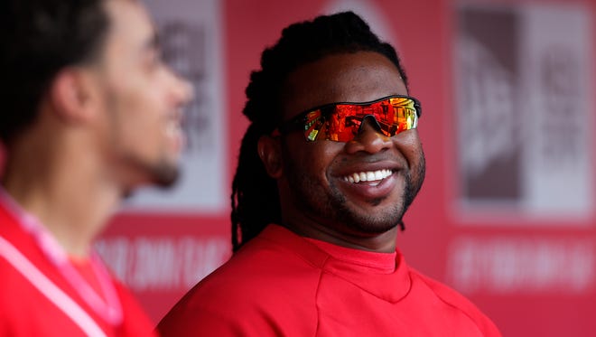 Reds starting pitcher Johnny Cueto talks with outfielder Billy Hamilton (left).