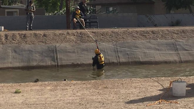 The Phoenix Police Dive Team searches for evidence in a Phoenix canal on April 25, 2017.