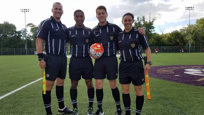 Stewarts Creek boys soccer coach Brooke Mayo (right) is shown at a recent men's national tournament event, where she was a referee. Mayo has been named a FIFA assistant referee.