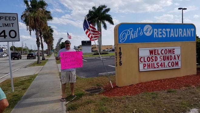 An animal cruelty protester at Phil's 41 in Punta Gorda where a political event for Amira Fox was held in May.