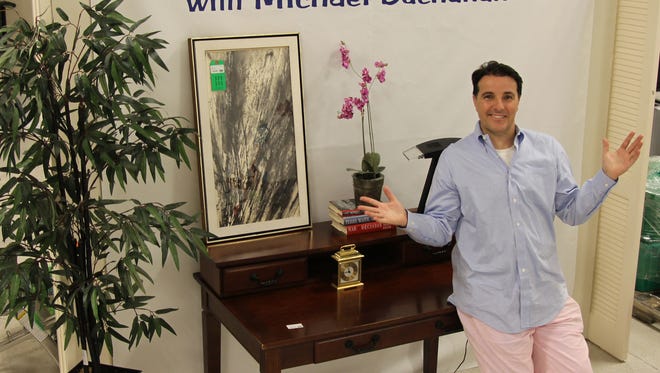 The "Thrifty Decorator," Michael Buchanan, showcasing one of his exclusive vignettes located at the Indian River Habitat for Humanity ReStore.