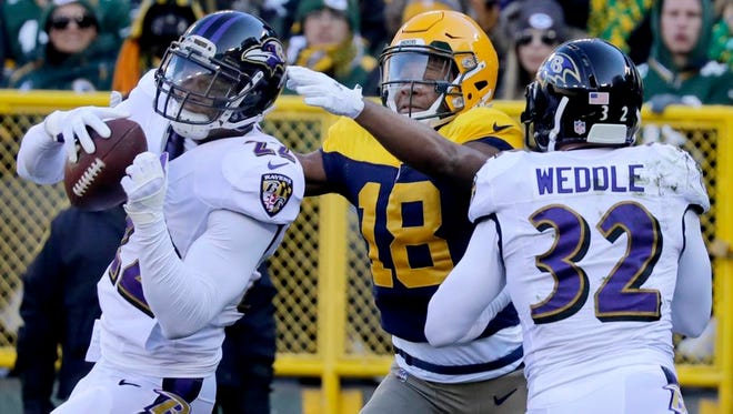 Baltimore Ravens cornerback Jimmy Smith intercepts a end zone pass to Green Bay Packers wide receiver Randall Cobb in the first quarter as the Green Bay Packers host the Baltimore Ravens on Sunday, November 19, 2017, at Lambeau Field in Green Bay, Wis.
