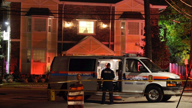 Nassau County police investigate a homicide in Farmingdale, N.Y., Tuesday, Oct. 28, 2014.  Police are investigating the link between a woman killed at the Farmingdale apartment building and a man struck by a LIRR train at the nearby train station. (AP Photo/Newsday, Howard Schnapp)   NYC LOCALS OUT