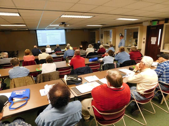 AARP volunteers prepare to aid seniors with tax forms