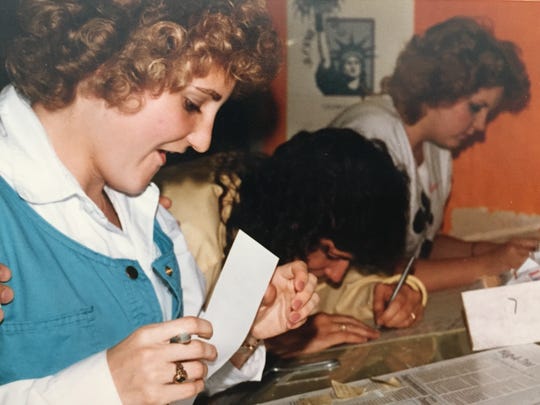 Tracy Scott (left) pastes up a page of the student newspaper at Glendale Community College. She's now director of marketing and strategic communications for the ASU Alumni Association.