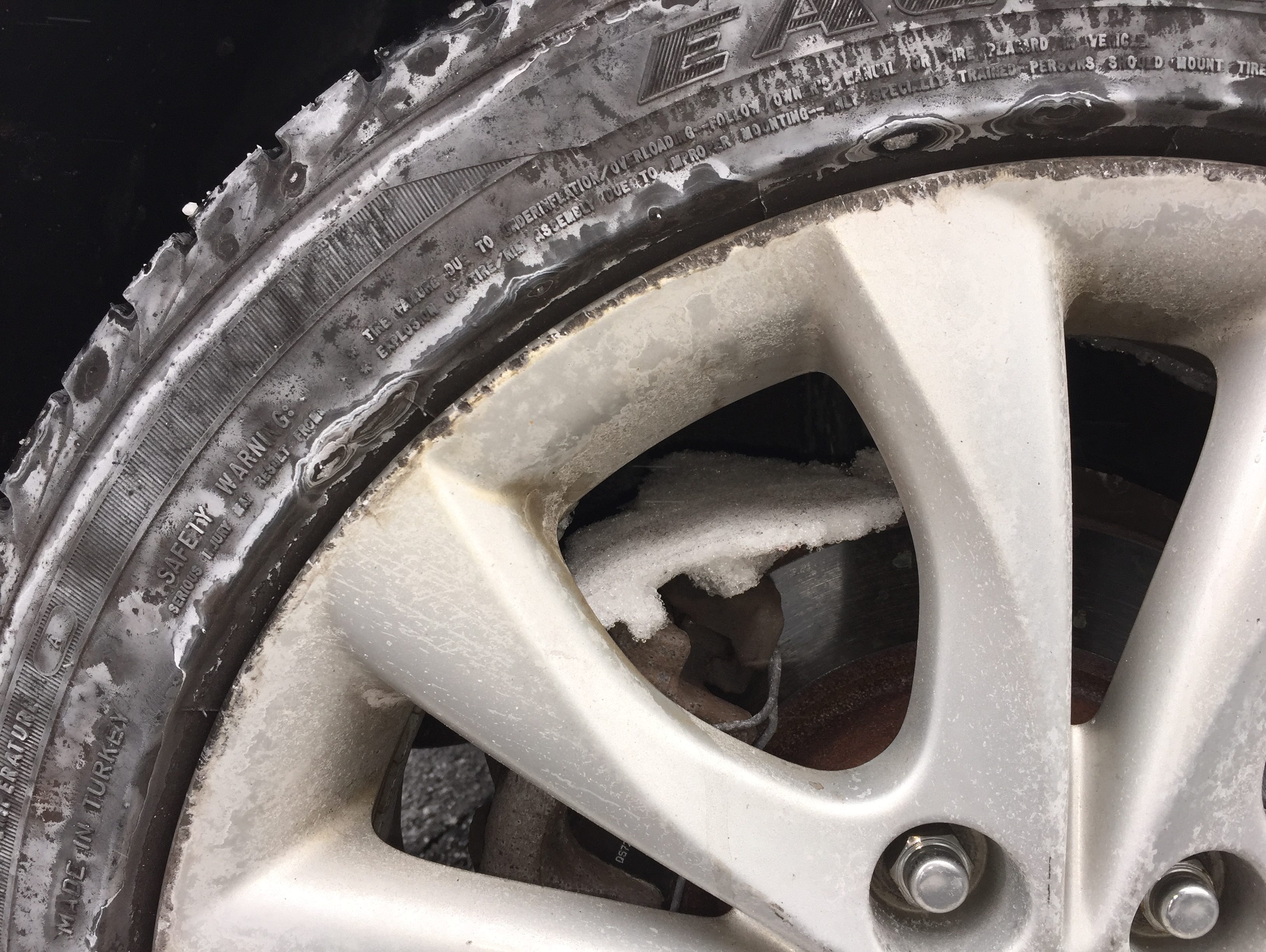 Snow buildup in the wheels of a car after Tuesday's winter storm.