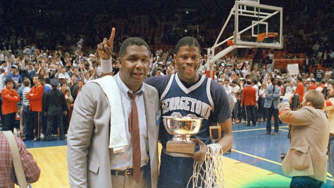 John Thompson poses with player Patrick Ewing after Georgetown defeated St. John's in the Big East Championship in New York in 1985. Thompson spoke his mind, shielded his players from the media and took positions that weren't always popular. He never shied away from sensitive topics, particularly the role of race in both sports and society, and he once famously walked off the court before a game to protest an NCAA rule because he felt it hurt minority athletes.