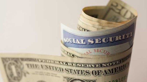 A Social security card rolled up in a wad of...