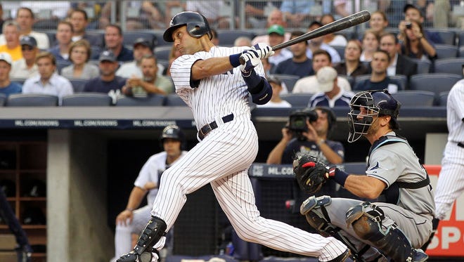 In this file photo Derek Jeter #2 of the New York Yankees hits a double in the first inning for career hit 2,998 while playing against the Tampa Bay Rays at Yankee Stadium on July 7, 2011 in the Bronx borough of New York City.