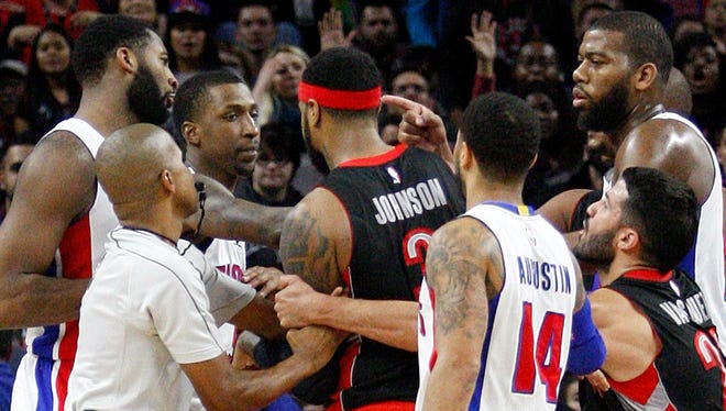 A scuffle breaks out after Detroit Pistons center Andre Drummond, left, committed a flagrant foul on Toronto Raptors forward James Johnson at the Palace of Auburn Hills.