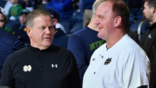 Feb 7, 2017; South Bend, IN, USA; Notre Dame Fighting Irish head football coach Brian Kelly and his defensive coordinator Mike Elko watch warmups before the game between the Notre Dame Fighting Irish and the Wake Forest Demon Deacons at the Purcell Pavilion. Mandatory Credit: Matt Cashore-USA TODAY Sports