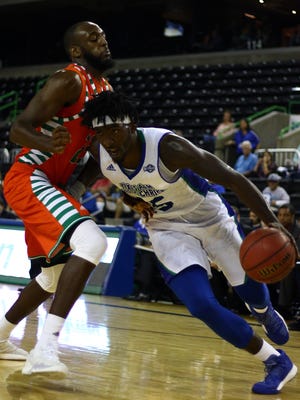 A&M-Corpus Christi's Rashawn Thomas drives to the basket against UTRGV's Dan Kimasa (23) during a non-conference men's basketball game at the American Bank Center on Tuesday, Nov. 29, 2016.