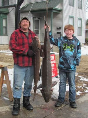 Robert Drexler of Oshkosh, and his son, Derek Drexler, 12, harvested their sturgeon out of the same hole on Saturday, Feb. 21, the last day of the 2015 sturgeon spearing season.